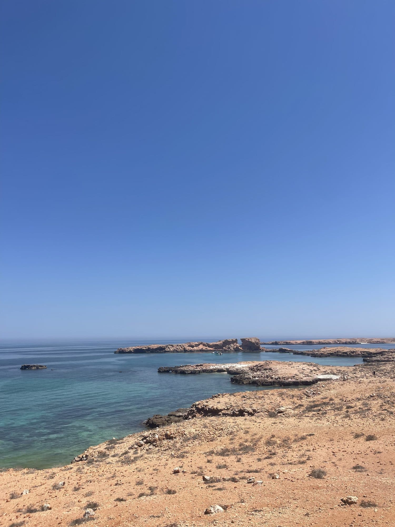 Small rocky islets in clear blue water at the Daymaniyat Islands
