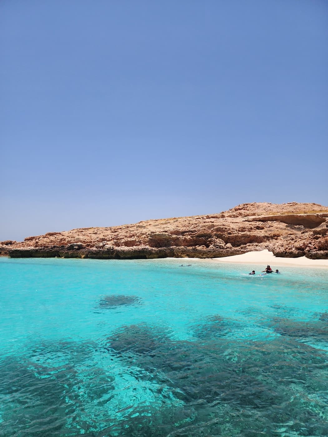 Brilliant turquoise water beside a Daymaniyat island, ideal for a private charter from Muscat